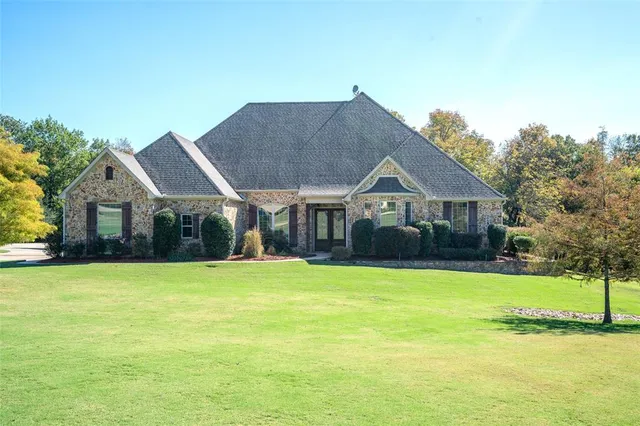 a front view of house with yard and swimming pool