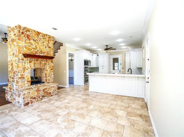 a kitchen with granite countertop a refrigerator and a stove top oven