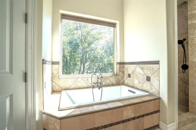 a spacious bathroom with a tub and sink