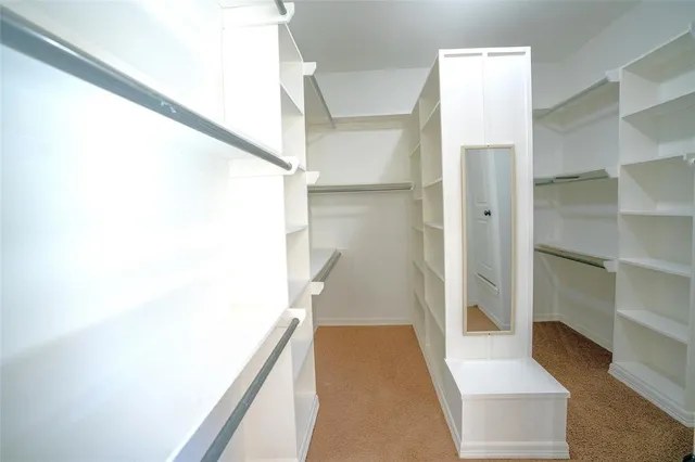 an empty room with a ceiling fan and window