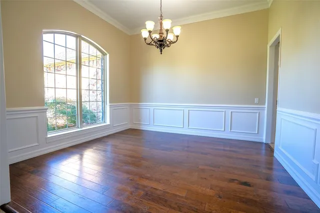 a view of a livingroom with wooden floor and a window