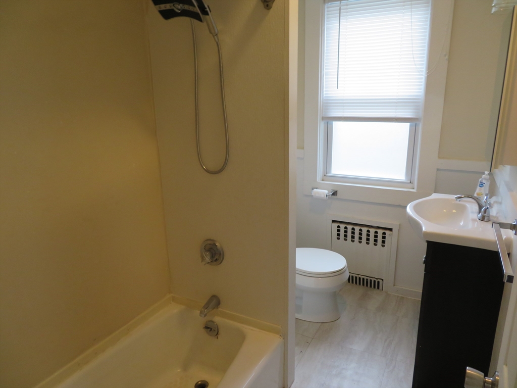 685 Cottage, Unit 1 New Bedford, MA 02745 - Photo 13 of 13 a bathroom with a toilet sink and a bathtub