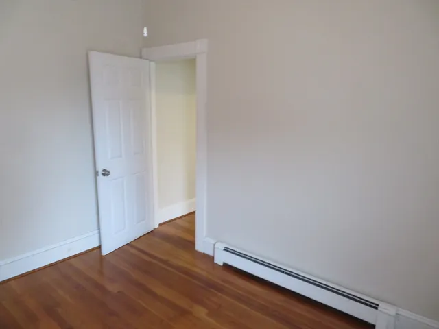 a view of room with wooden floor