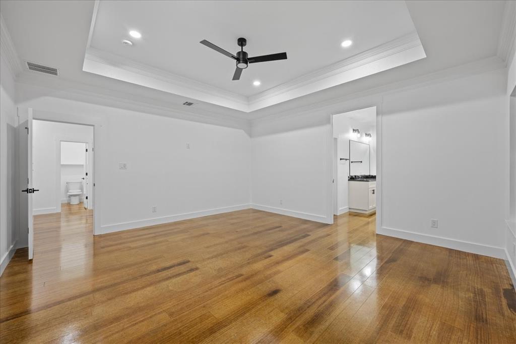 3028 West Frk Way Springtown, TX 76082 - Photo 11 of 24 Retreat to your own sanctuary featuring crown molding, recessed lighting, wood-style flooring, ceiling fan, and a tray ceiling