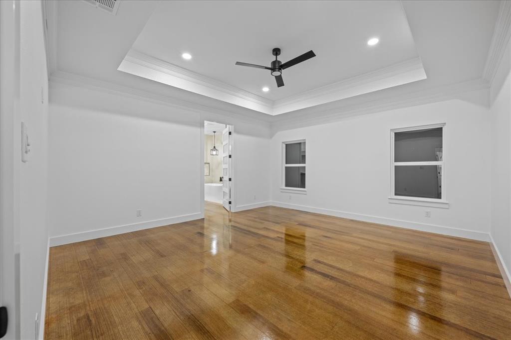 3028 West Frk Way Springtown, TX 76082 - Photo 15 of 31 Retreat to your own sanctuary featuring crown molding, recessed lighting, wood-style flooring, ceiling fan, and a tray ceiling