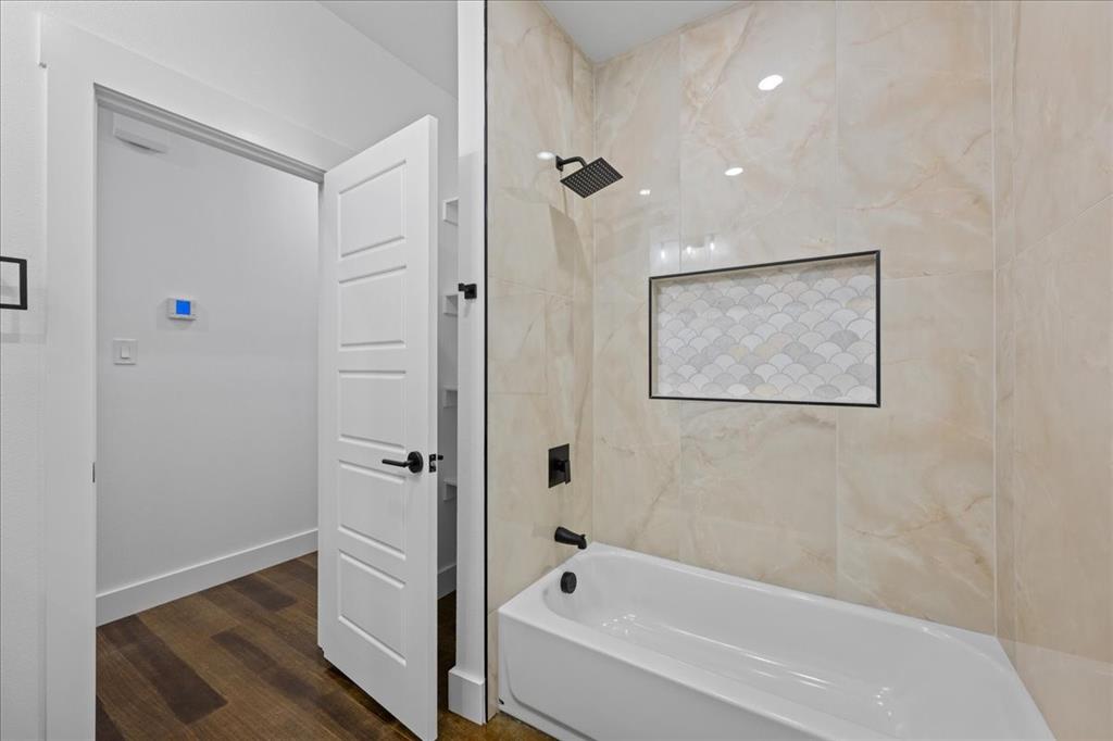 3028 West Frk Way Springtown, TX 76082 - Photo 17 of 24 Bathroom featuring wood-stye flooring, vanity, and a tub/shower combination