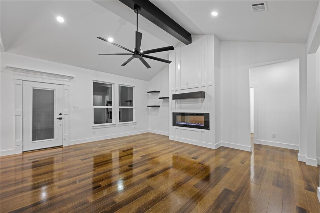 3028 West Frk Way Springtown, TX 76082 - Photo 7 of 24 Living room featuring beam ceiling, wood-style flooring, a large fireplace, ceiling fan, and vaulted ceiling