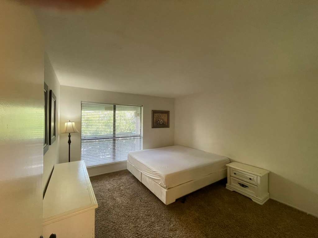 7950 North Stadium Drive, Unit 172 Houston, TX 77030 - Photo 11 of 13 a spacious bedroom with a bed and large window