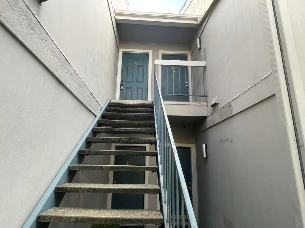 7950 North Stadium Drive, Unit 172 Houston, TX 77030 - Photo 3 of 13 a view of staircase with wooden floor and white walls