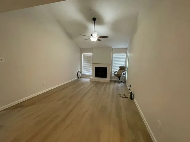 wooden floor in an empty room with a fireplace