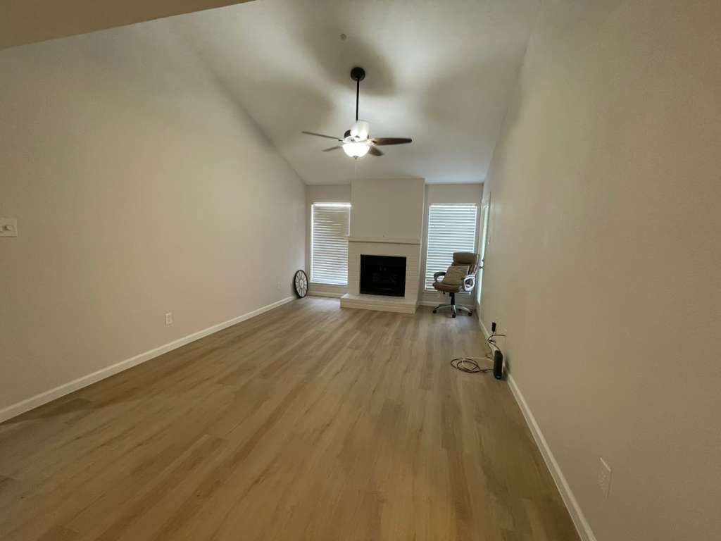 7950 North Stadium Drive, Unit 172 Houston, TX 77030 - Photo 5 of 13 wooden floor in an empty room with a fireplace