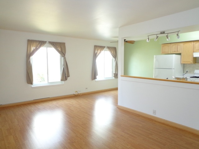 1368 Quaker Lane Prospect Heights, IL 60070 - Photo 2 of 14 an empty room with wooden floor and windows