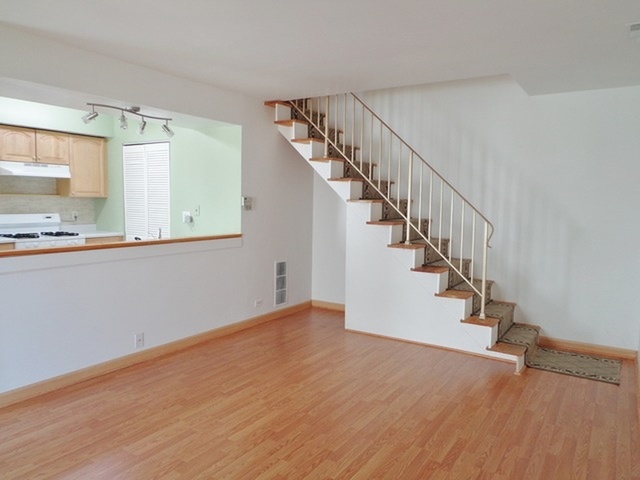 1368 Quaker Lane Prospect Heights, IL 60070 - Photo 3 of 14 a view of hallway with wooden floor and staircase