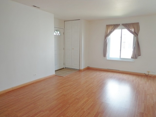 1368 Quaker Lane Prospect Heights, IL 60070 - Photo 4 of 14 an empty room with wooden floor and windows