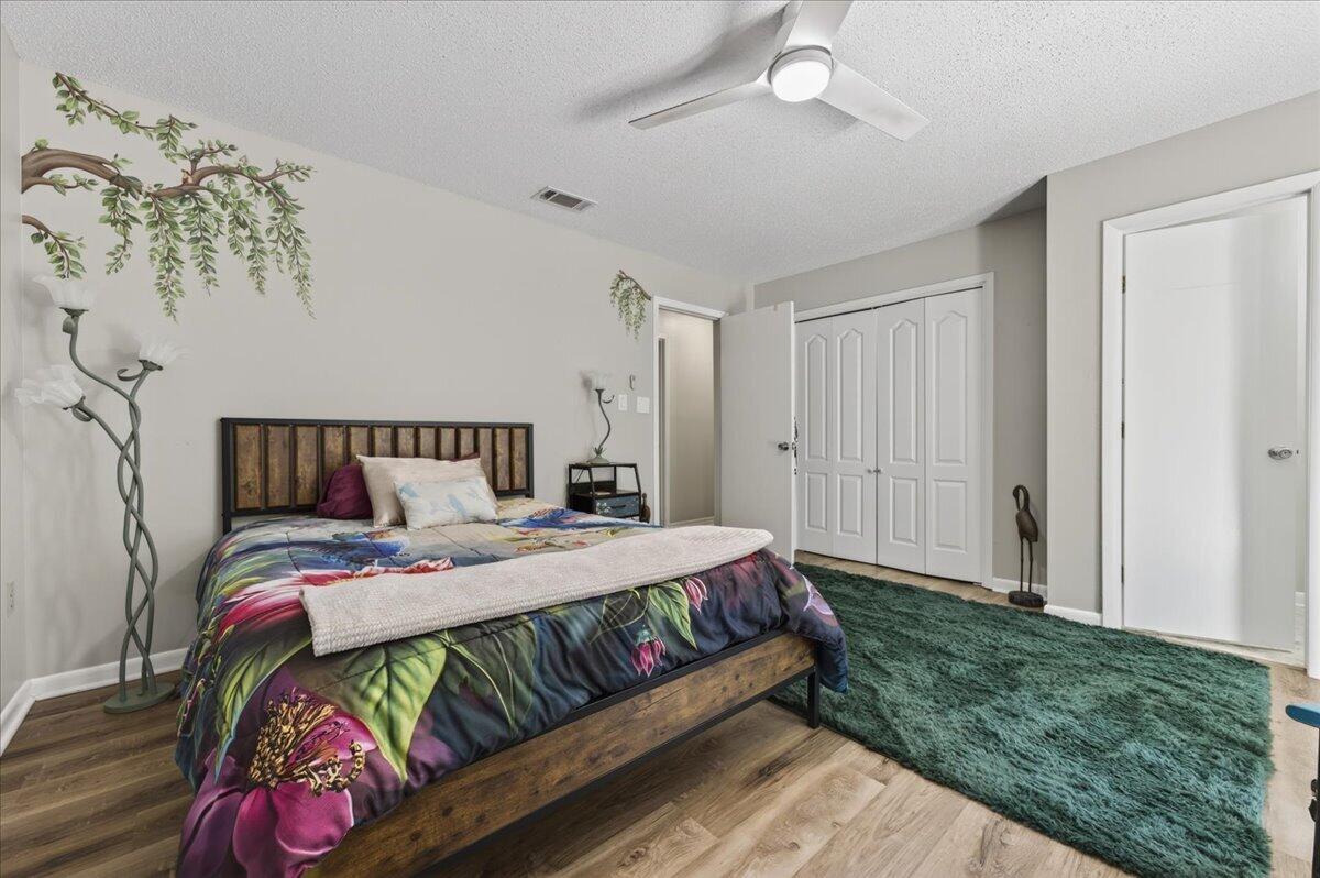 210 Shell Drive Crestview, FL 32536 - Photo 29 of 67 a bedroom with a bed and a chandelier