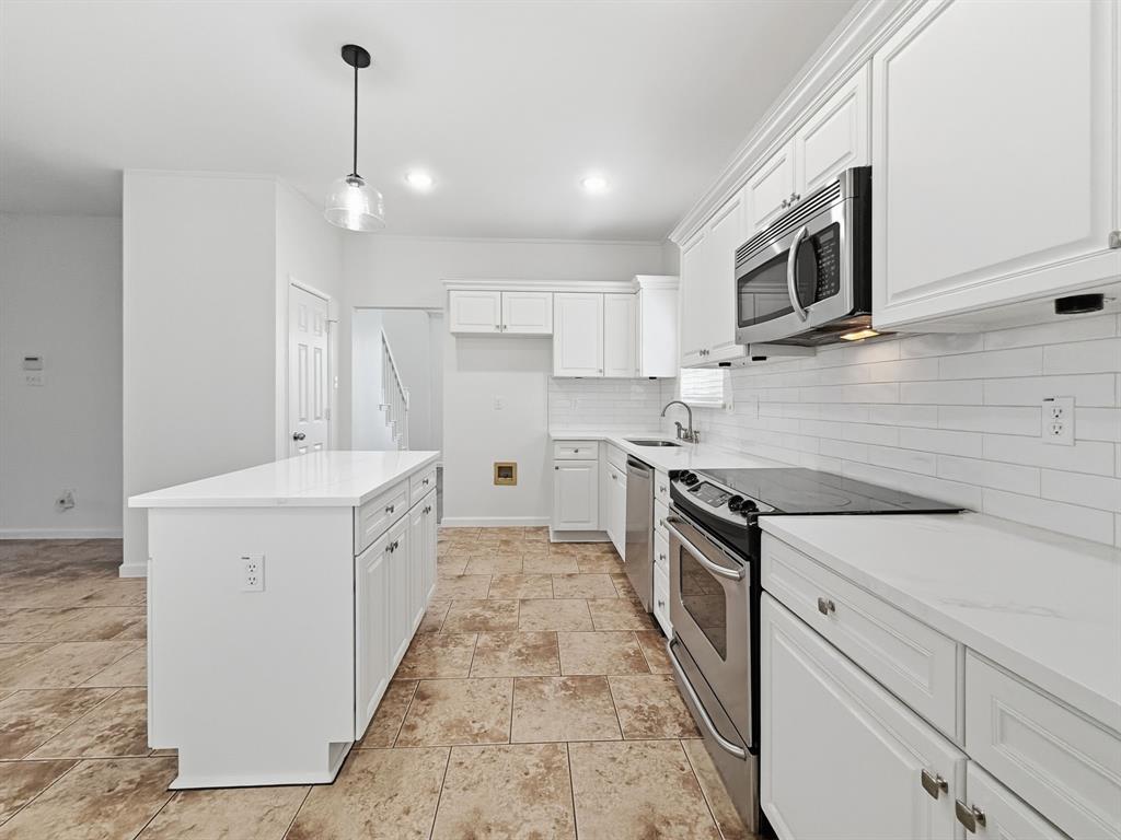 730 Fairlawn Street Allen, TX 75002 - Photo 15 of 40 a kitchen with stainless steel appliances granite countertop a sink and a stove