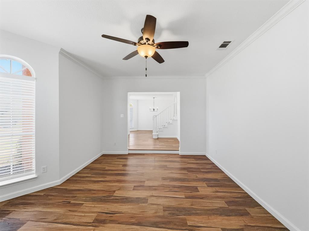 730 Fairlawn Street Allen, TX 75002 - Photo 7 of 40 a bedroom with a bed and a chandelier