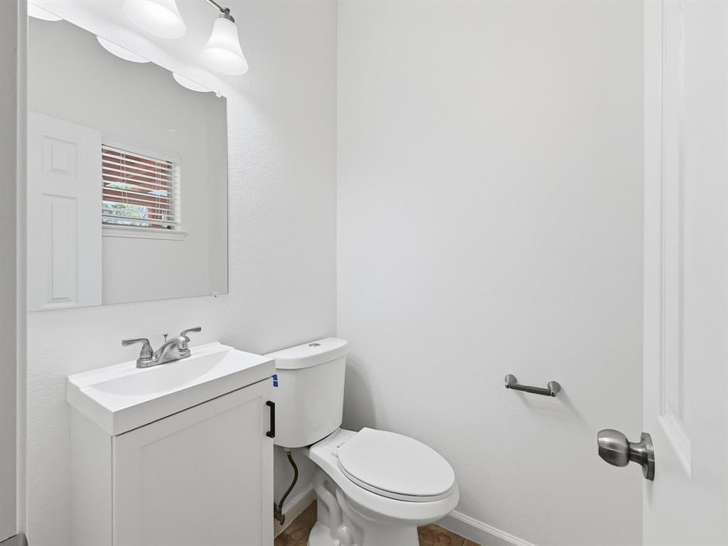 730 Fairlawn Street Allen, TX 75002 - Photo 9 of 40 a bathroom with a toilet a sink and mirror