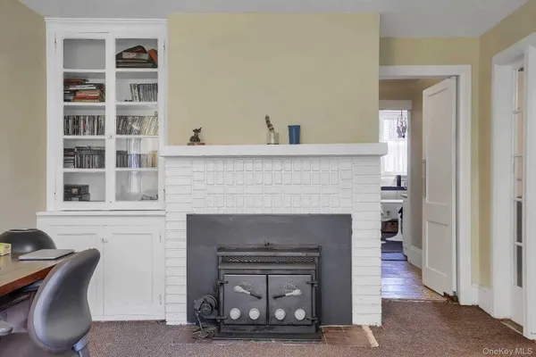 a living room with a fireplace and a wooden floor