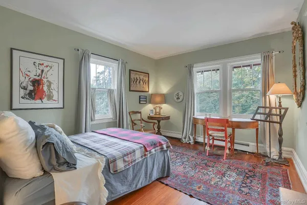 a bedroom with a bed and a large window