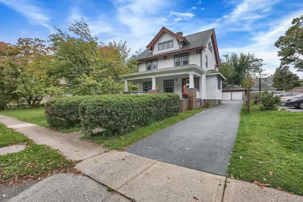 a front view of a house with a garden