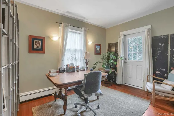 a view of a dining room with furniture and a window