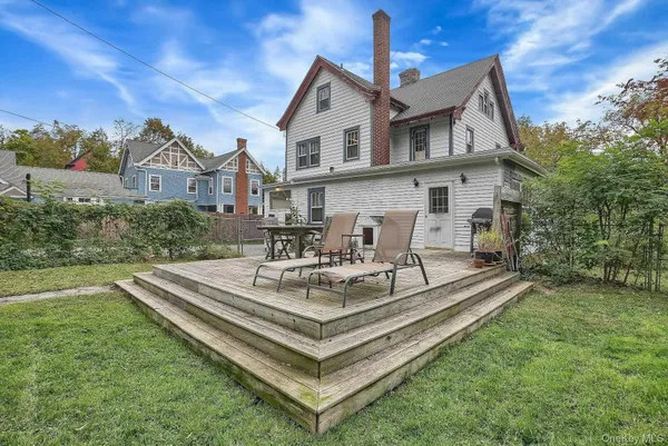 a view of a house with a chairs in a patio