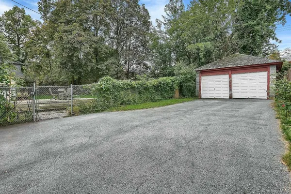 a view of a backyard with large trees