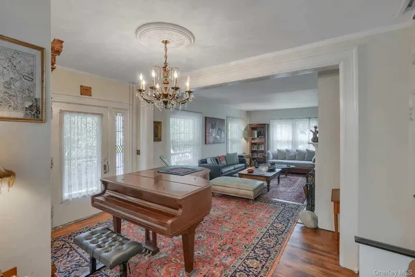 a living room with furniture and a chandelier