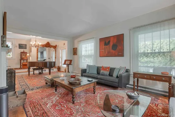 a living room with furniture a rug and a large window