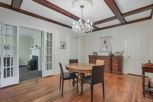 a view of a dining room with furniture wooden floor and chandelier