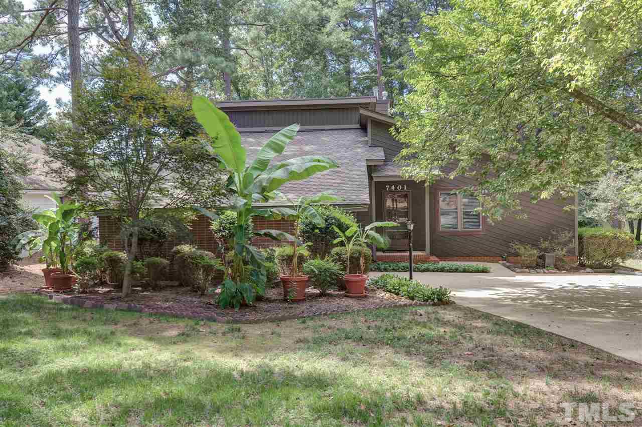 a view of a house with a yard and tree s