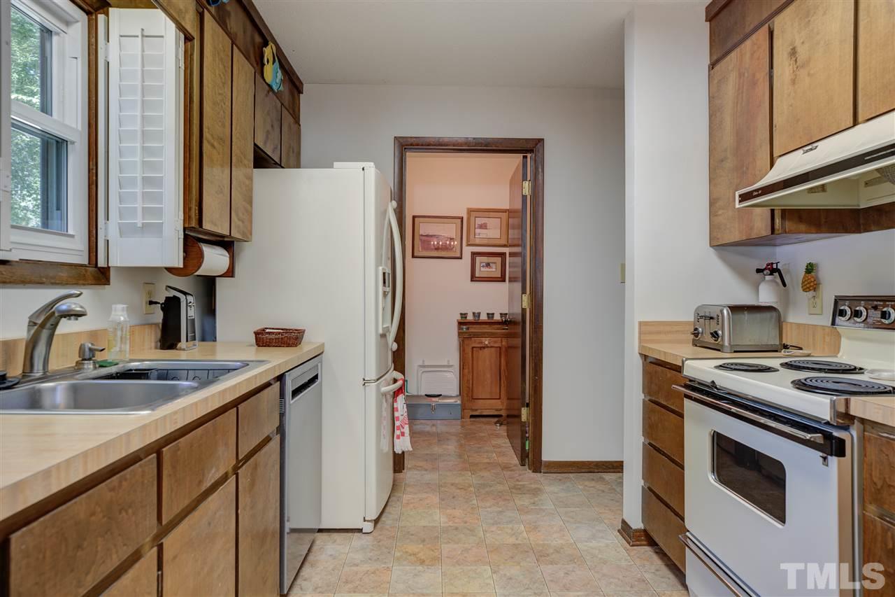 7401 Valley Run Drive Raleigh, NC 27615 - Photo 6 of 22 a kitchen with stainless steel appliances granite countertop a sink stove and refrigerator