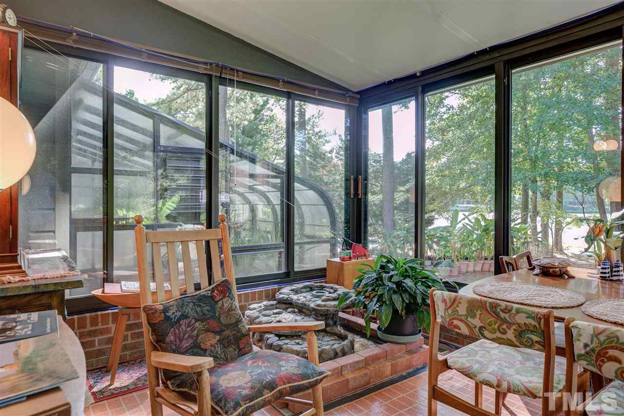 7401 Valley Run Drive Raleigh, NC 27615 - Photo 8 of 22 a view of a dining room with furniture large windows and wooden floor