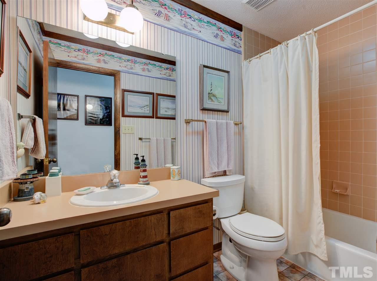 7401 Valley Run Drive Raleigh, NC 27615 - Photo 10 of 22 a bathroom with a sink toilet and shower