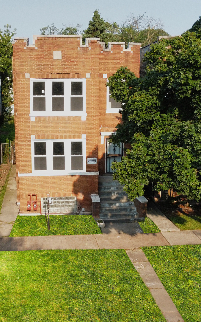 6830 South Michigan Avenue Chicago, IL 60637 - Photo 1 of 10 a front view of a house with a yard table and chairs