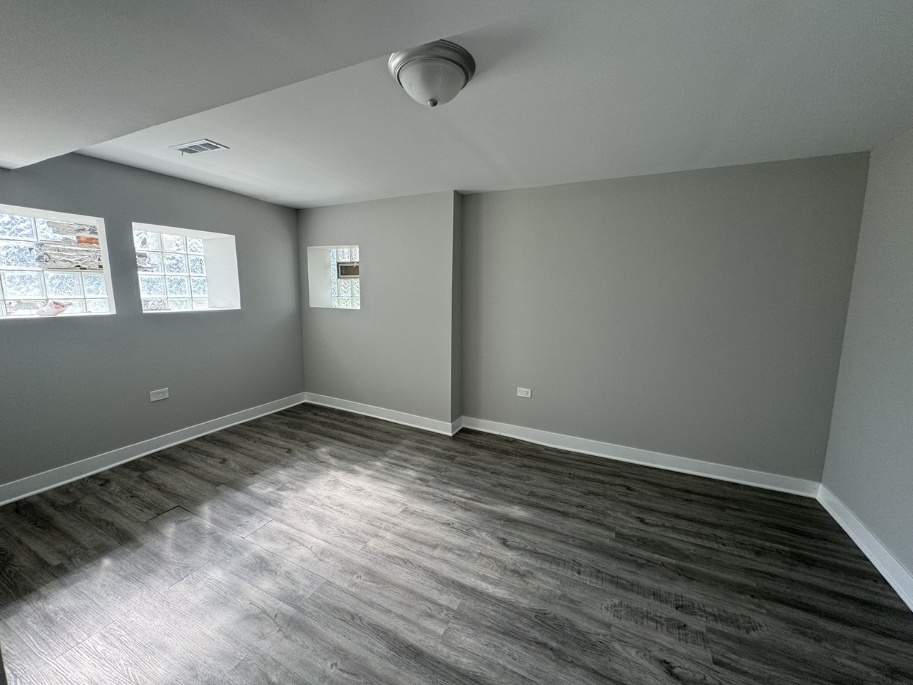 6830 South Michigan Avenue Chicago, IL 60637 - Photo 7 of 10 an empty room with wooden floor and windows
