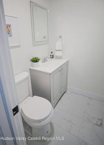 a white toilet sitting next to a bathroom sink