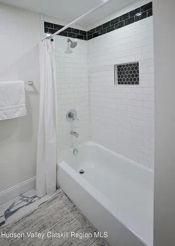 a bathroom with a shower and a bath tub