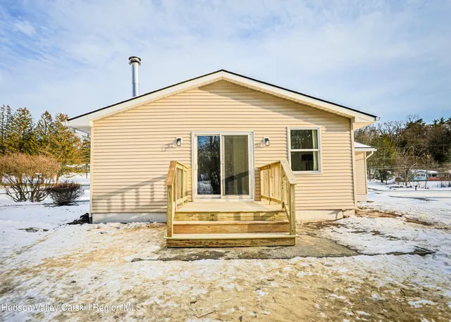 a view of a house with snow on the road
