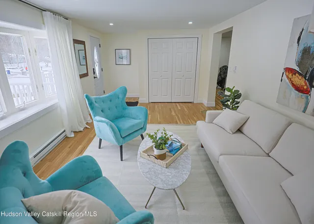 a living room with furniture and a chair