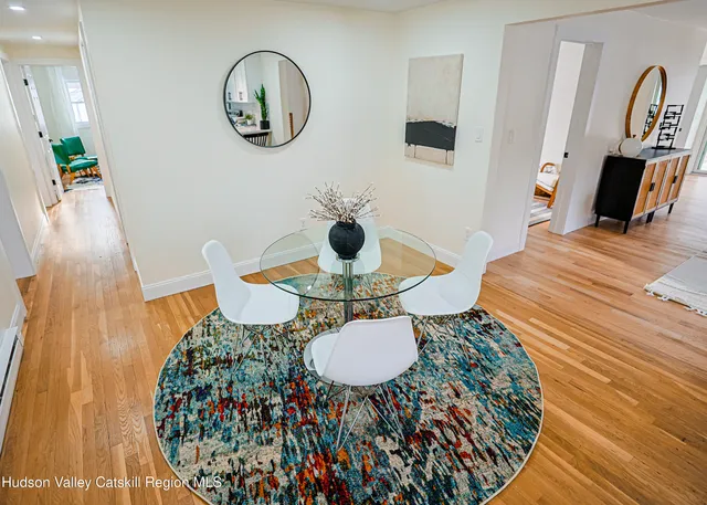 a view of a dining room with furniture and wooden floor