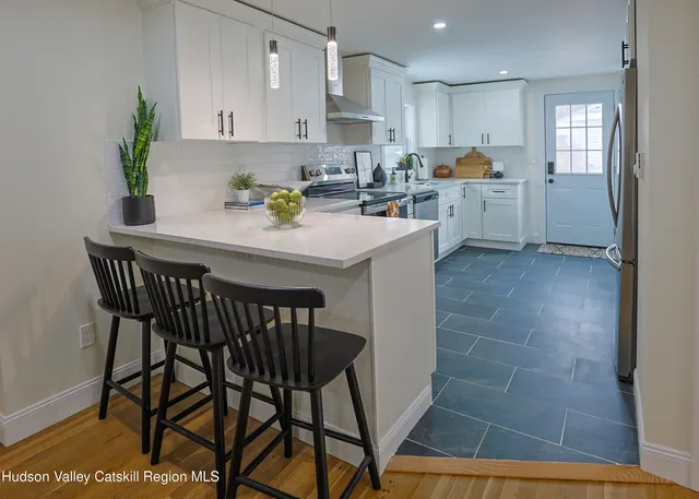 a kitchen with cabinets a sink and appliances