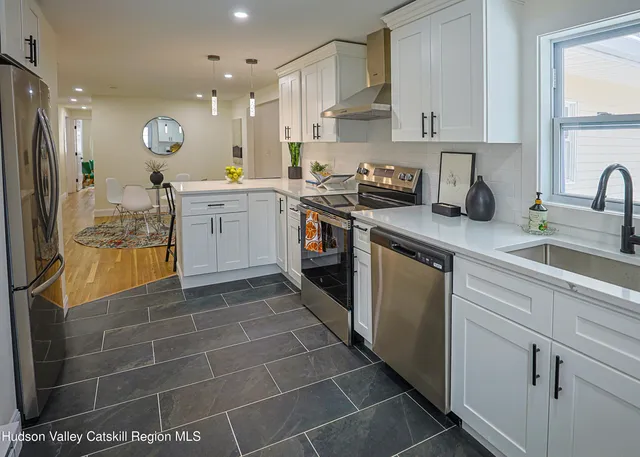 a kitchen with a sink cabinets and stainless steel appliances