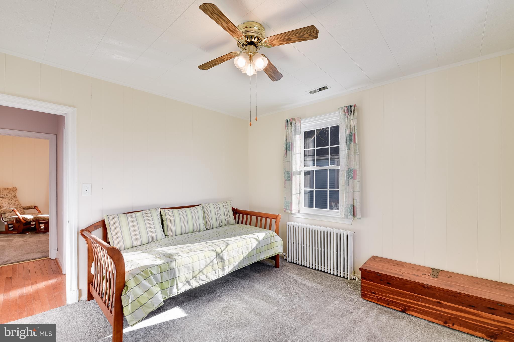 5533 Hutton Avenue Baltimore, MD 21207 - Photo 13 of 39 a bedroom with furniture and window