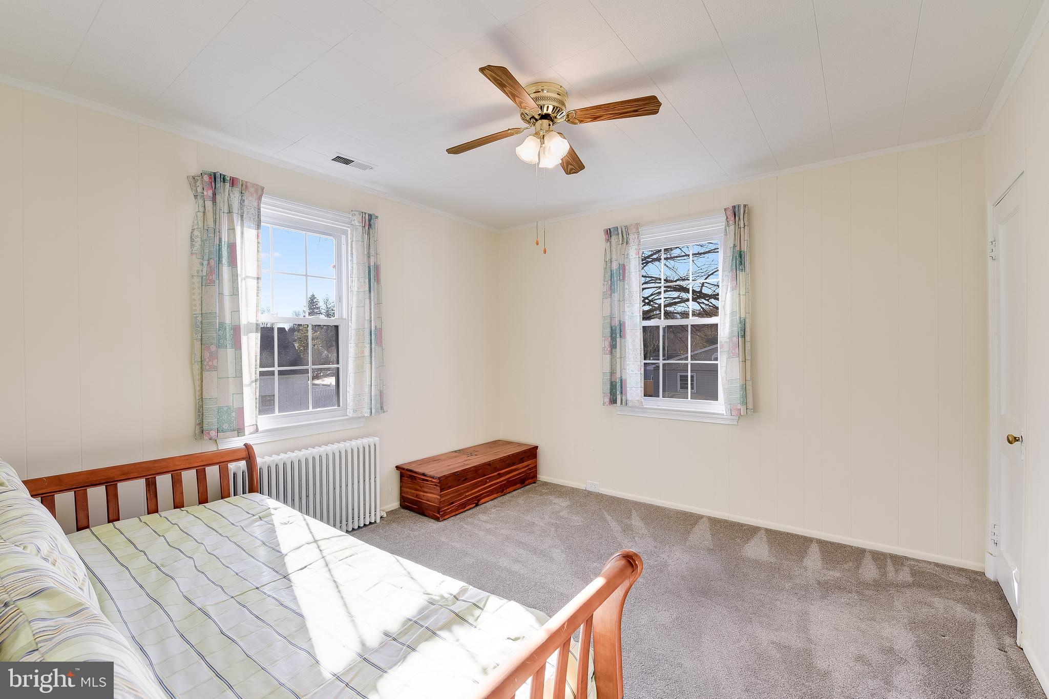 5533 Hutton Avenue Baltimore, MD 21207 - Photo 14 of 39 a bedroom with furniture and window