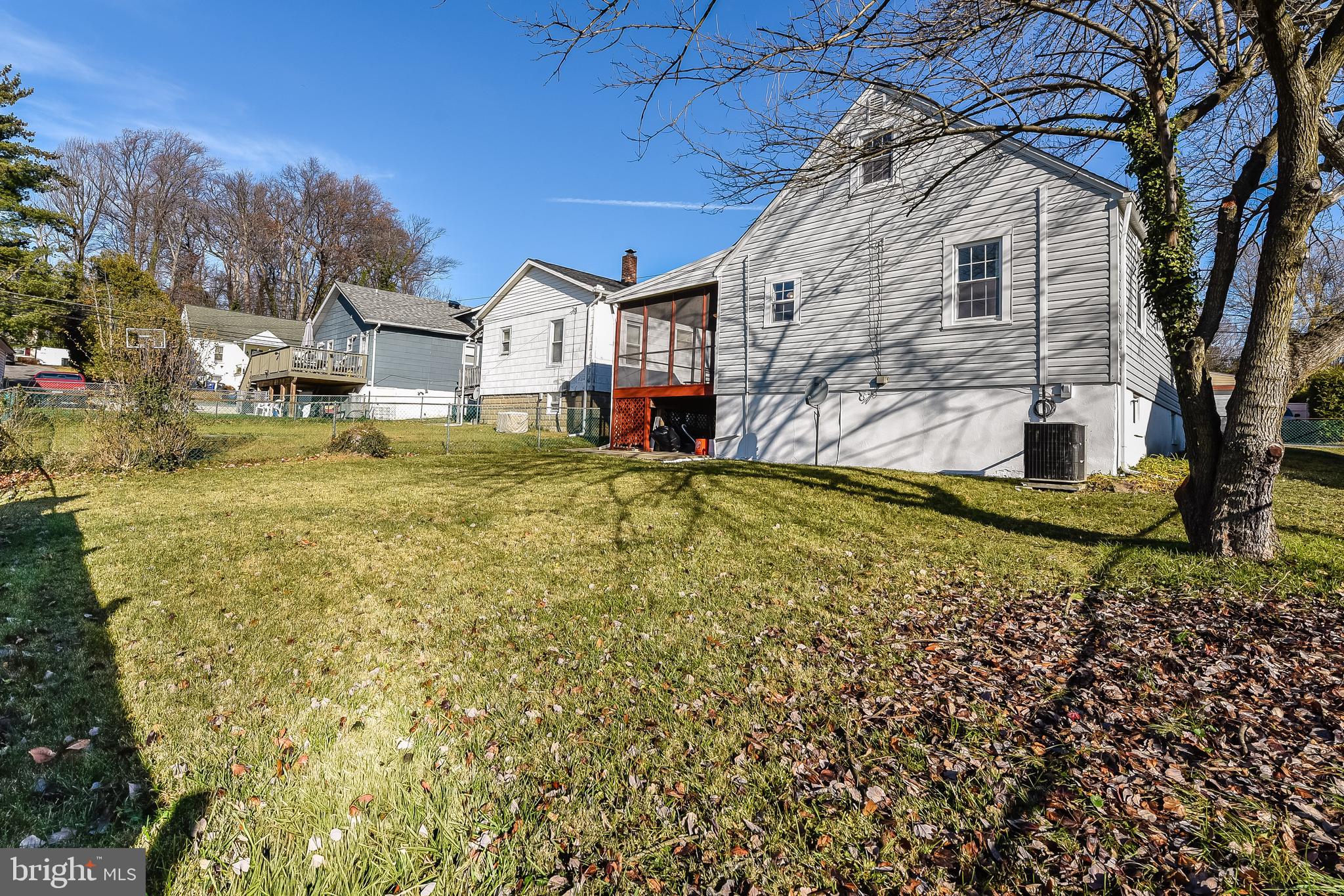 5533 Hutton Avenue Baltimore, MD 21207 - Photo 28 of 39 a view of a house with a big yard and large tree