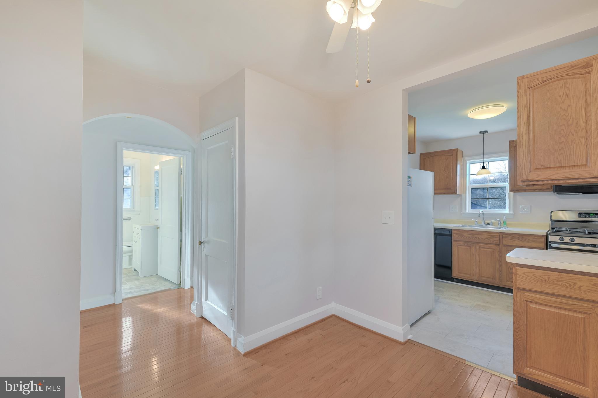 5533 Hutton Avenue Baltimore, MD 21207 - Photo 34 of 39 a view of a kitchen with a sink dishwasher and fireplace