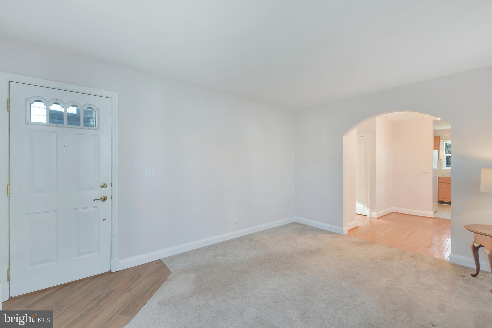 5533 Hutton Avenue Baltimore, MD 21207 - Photo 35 of 39 an empty room with wooden floor and windows