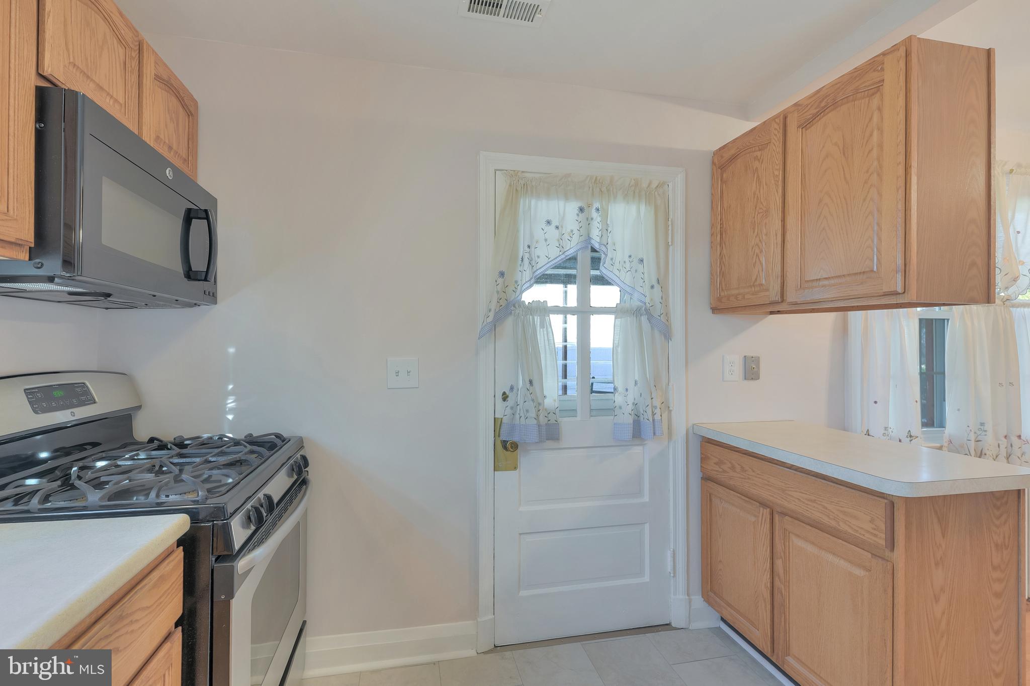 5533 Hutton Avenue Baltimore, MD 21207 - Photo 4 of 39 a kitchen with stainless steel appliances granite countertop a sink and a stove top oven